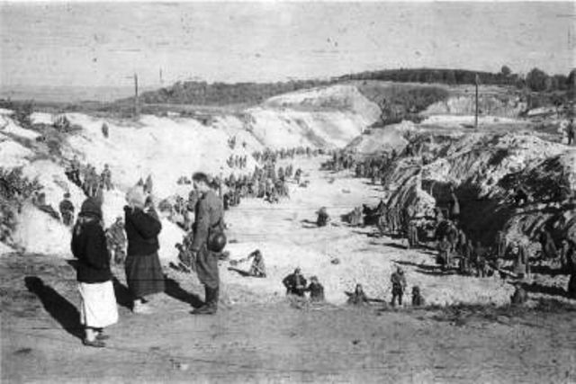 Babi-Yar Ukrainian women question a German soldier overlooking the POW workers in the ravine